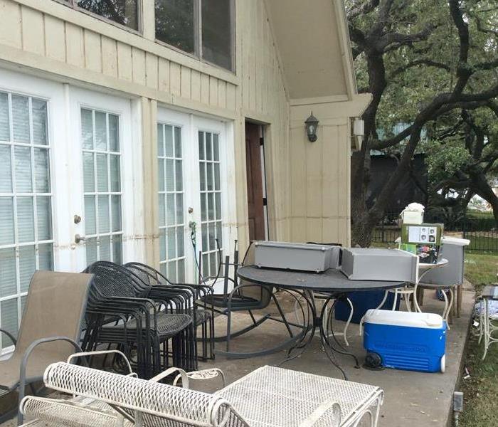 outdoor furniture stacked on a back porch
